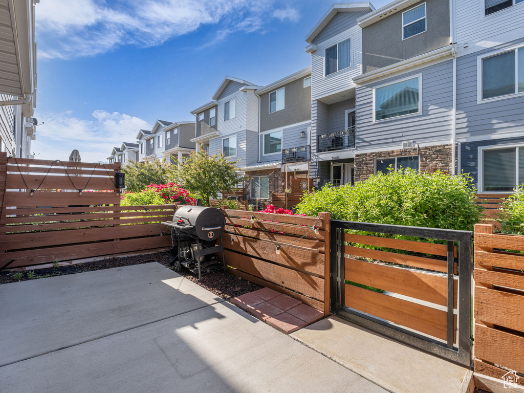 View of patio / terrace featuring a residential view, area for grilling, and a gate