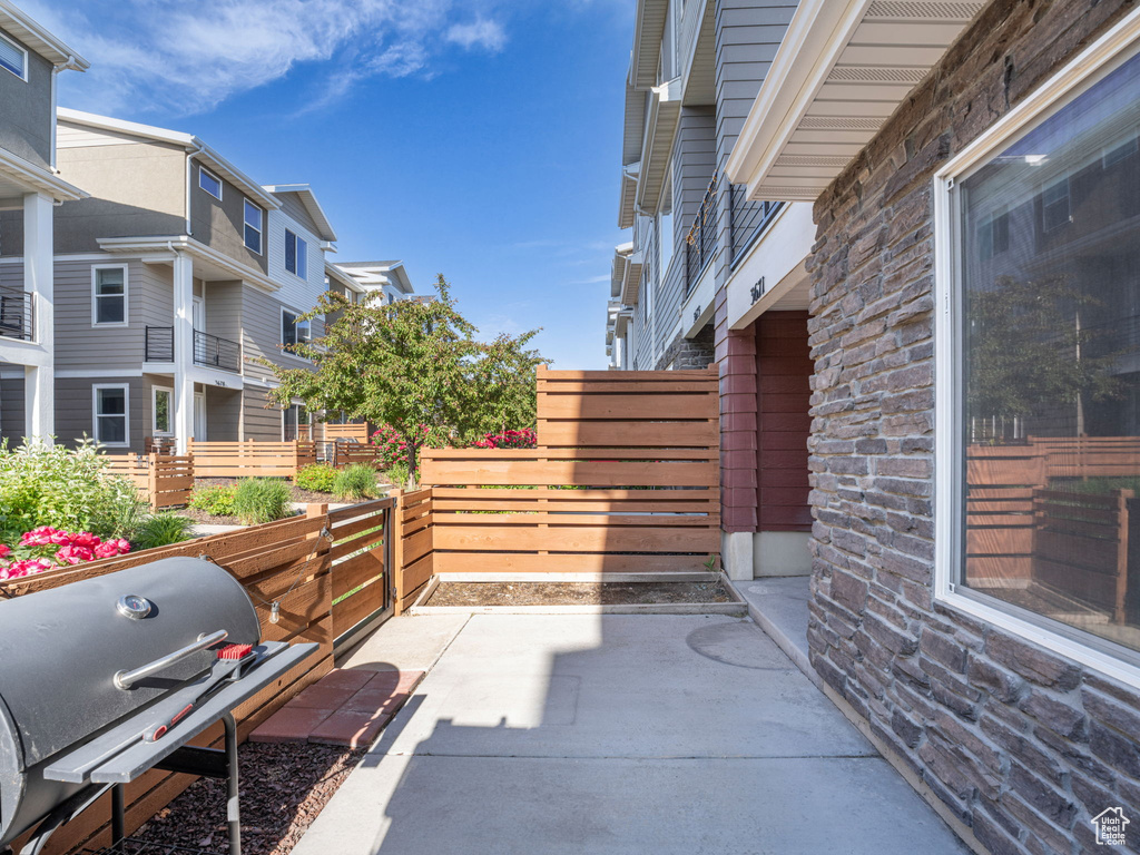 View of patio / terrace featuring a grill and a residential view