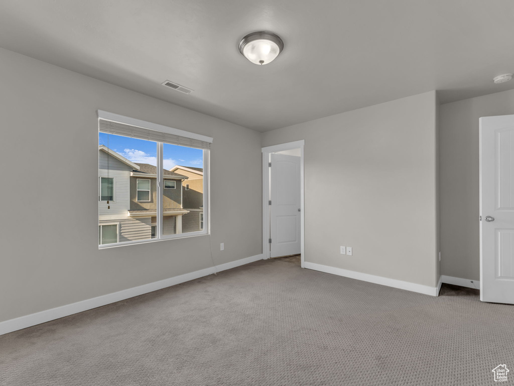 Unfurnished room with carpet flooring and baseboards