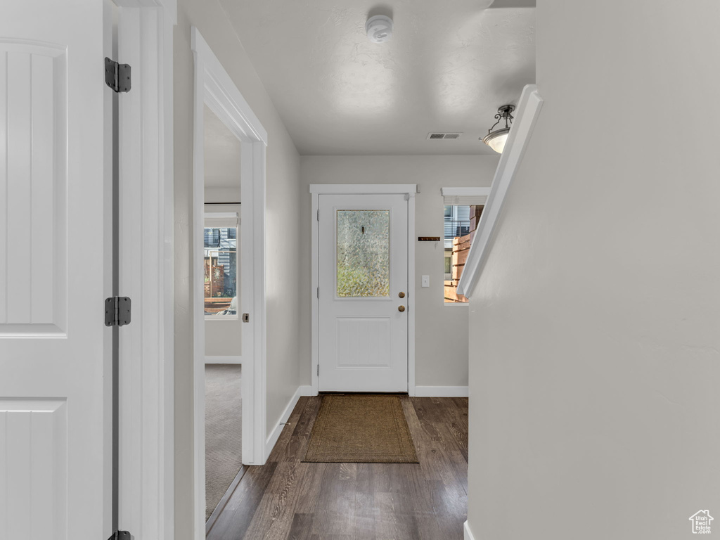 Foyer entrance with wood finished floors and baseboards