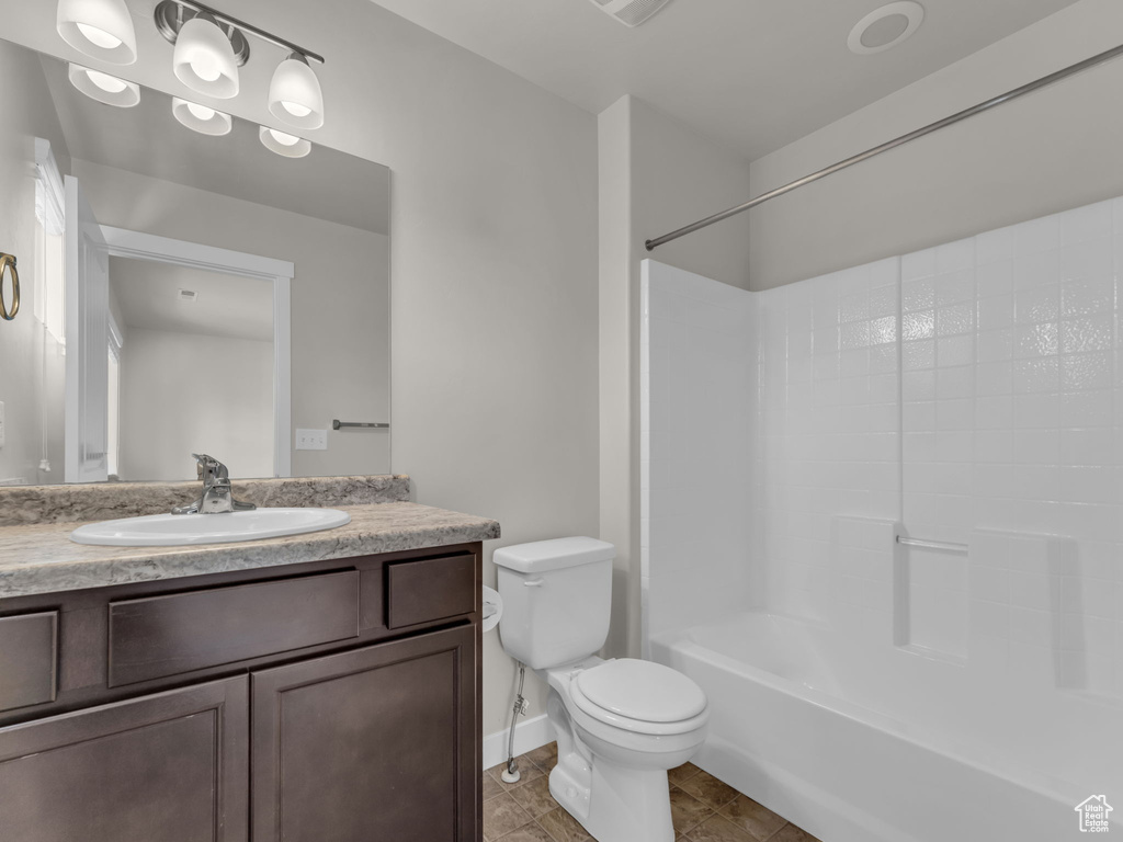 Bathroom featuring vanity, toilet, washtub / shower combination, tile patterned floors, and baseboards