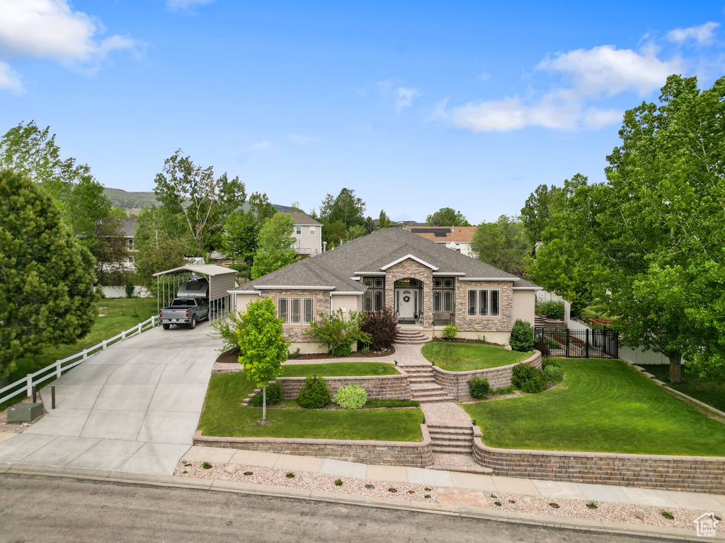 Ranch-style house featuring a carport, driveway, and brick siding