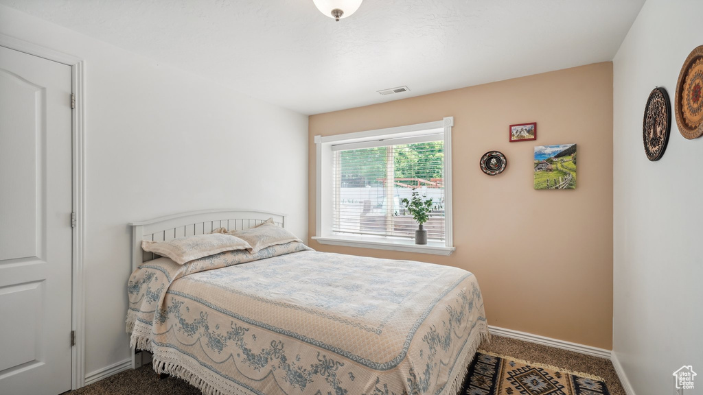 Carpeted bedroom with baseboards