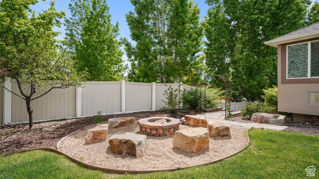 View of yard with an outdoor fire pit
