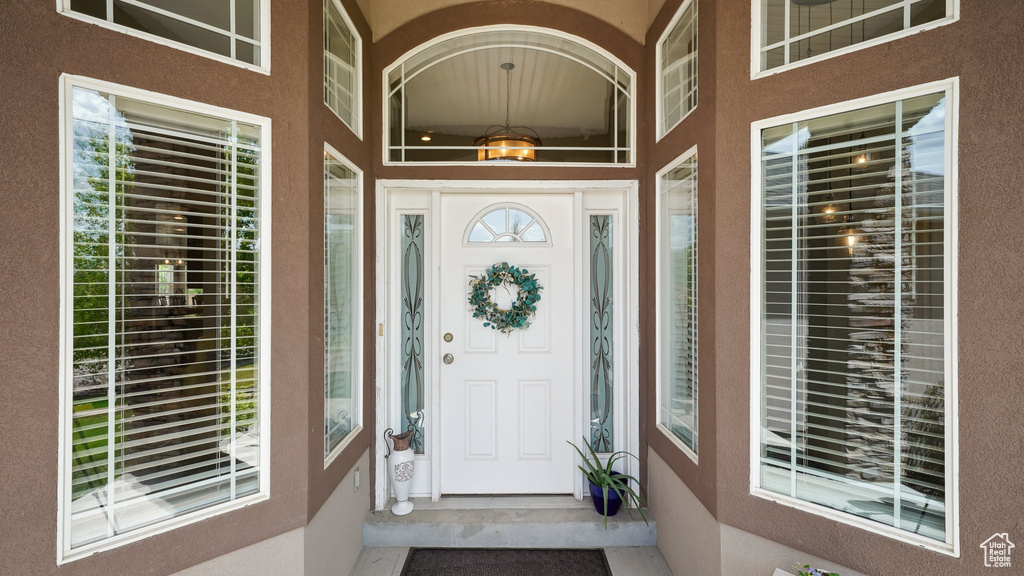 Doorway to property featuring stucco siding
