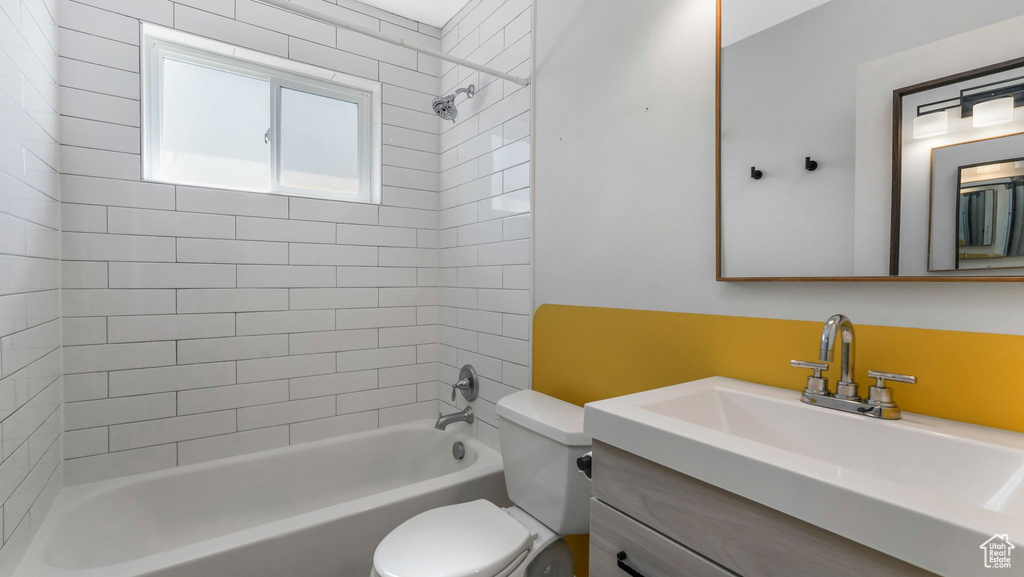 Full bathroom featuring toilet, vanity, and  shower combination