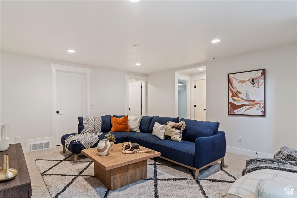 Living room featuring light carpet, recessed lighting, and baseboards
