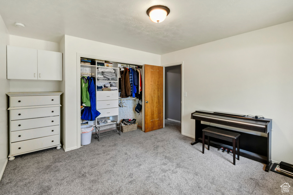 Carpeted bedroom with a closet