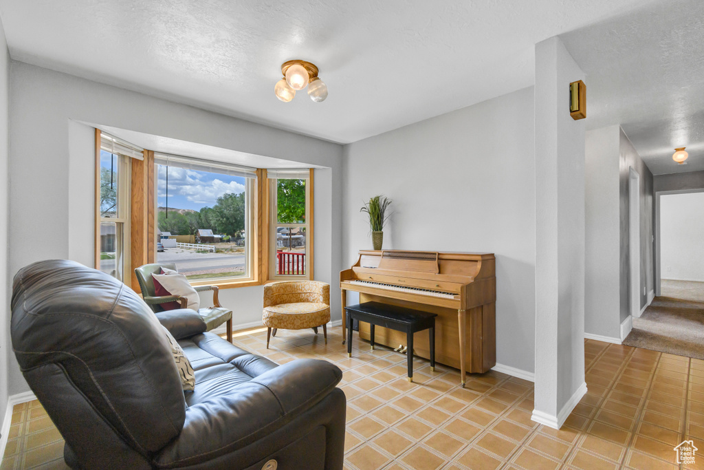 Living area with baseboards and light tile patterned floors