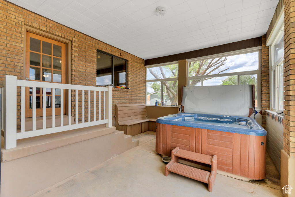 Sunroom / solarium featuring a jacuzzi and plenty of natural light
