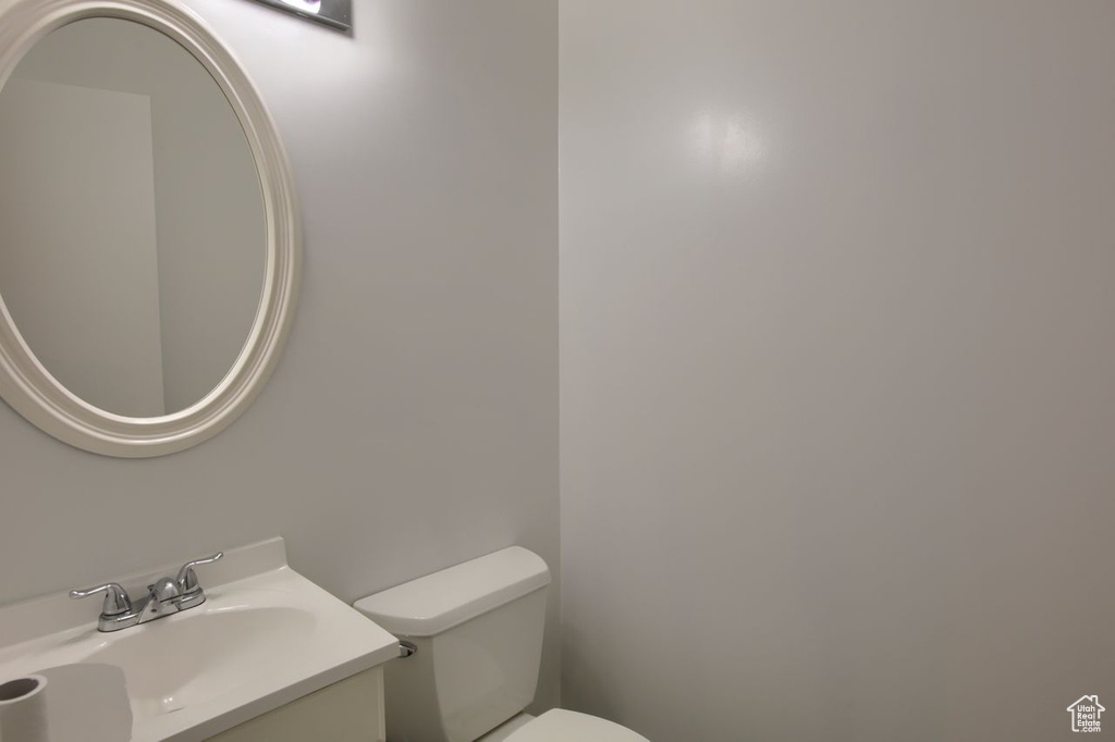 Half bath featuring toilet and vanity