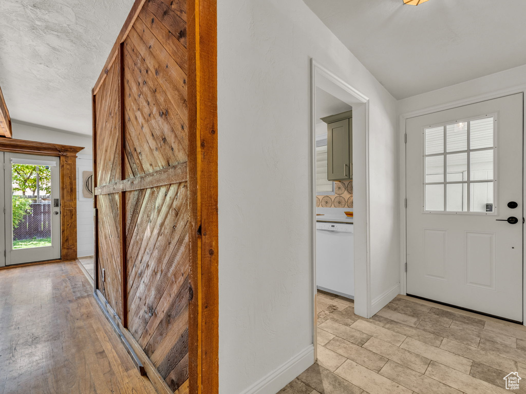 Foyer with baseboards and light wood-style floors