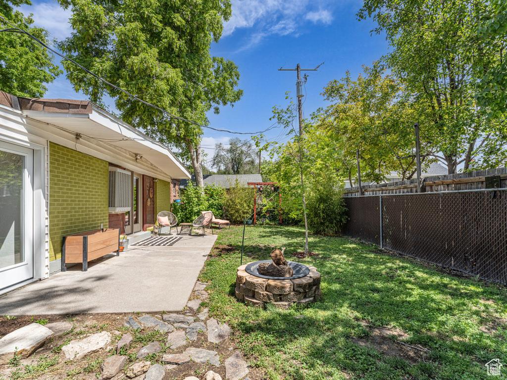 View of yard with a patio and a fire pit