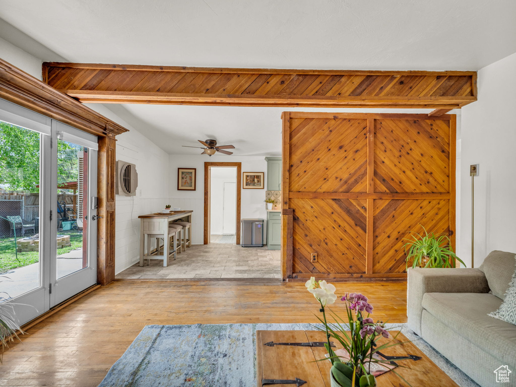 Living area with light wood-type flooring and a ceiling fan