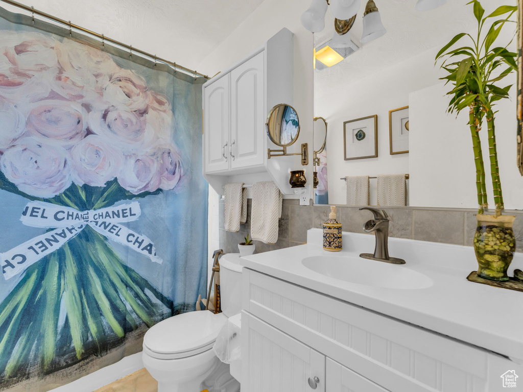 Full bathroom with toilet and vanity