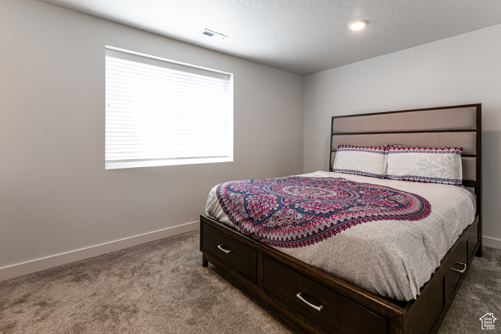 Bedroom featuring carpet floors and baseboards