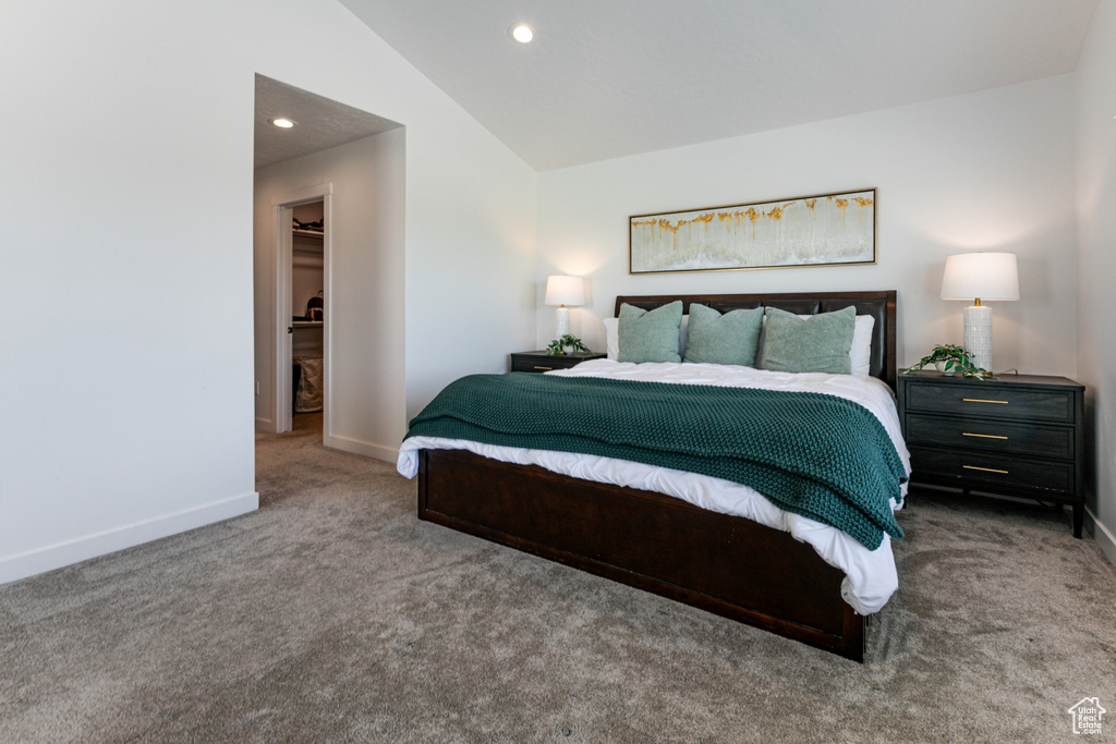 Bedroom featuring carpet floors, baseboards, vaulted ceiling, a spacious closet, and recessed lighting