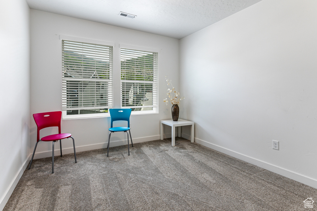 Sitting room featuring carpet floors and baseboards