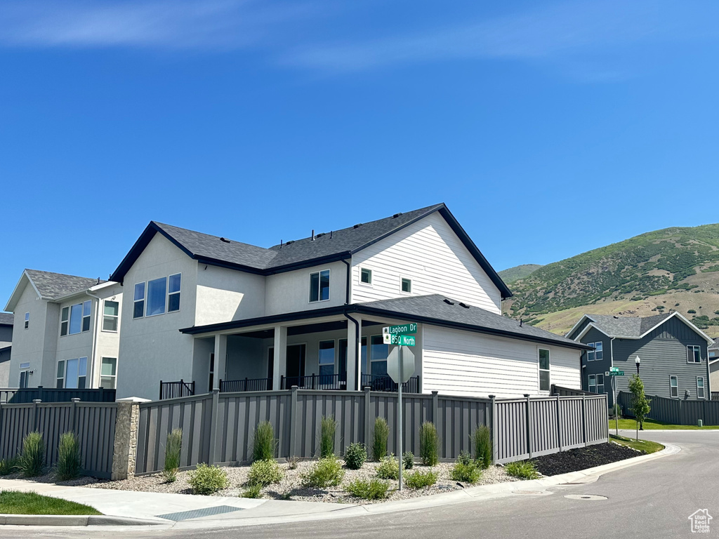 View of front of home with a mountain view and a residential view