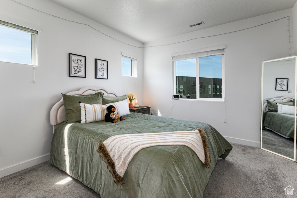 Carpeted bedroom with baseboards