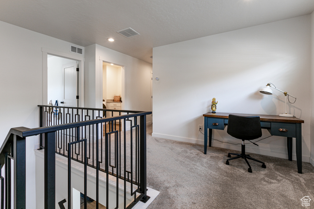 Carpeted home office featuring baseboards and recessed lighting