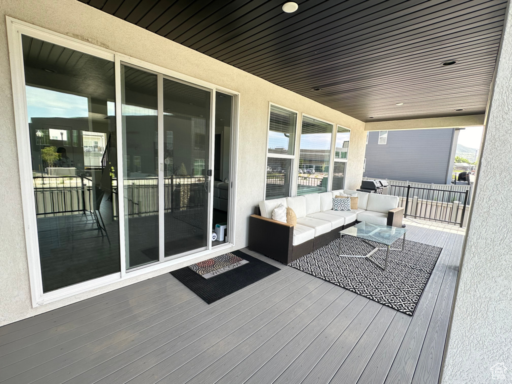 Wooden deck featuring an outdoor living space