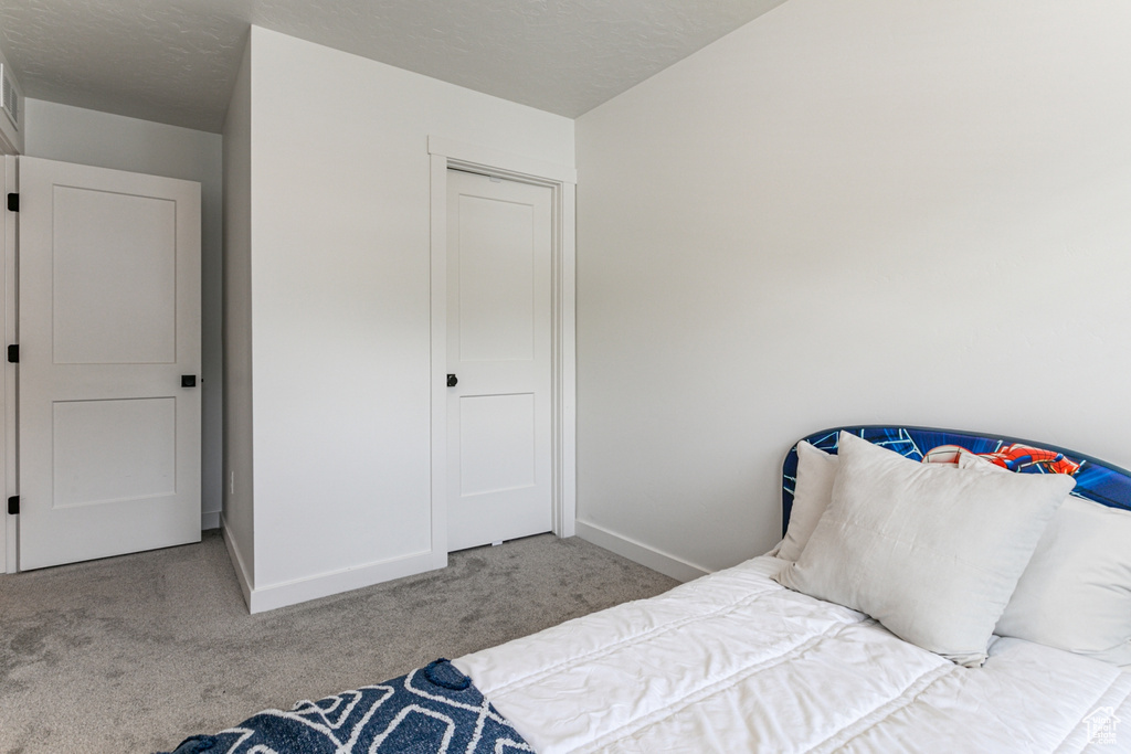 Carpeted bedroom with baseboards