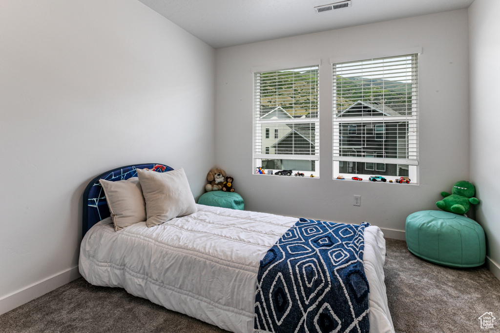 Carpeted bedroom featuring baseboards