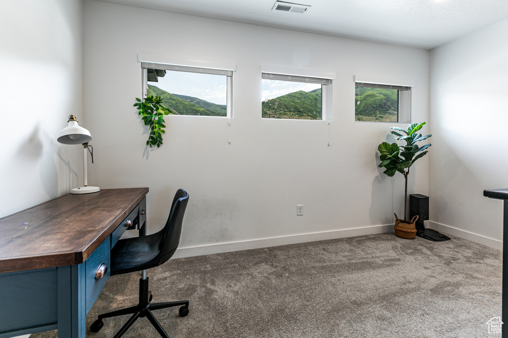 Home office featuring carpet flooring and baseboards