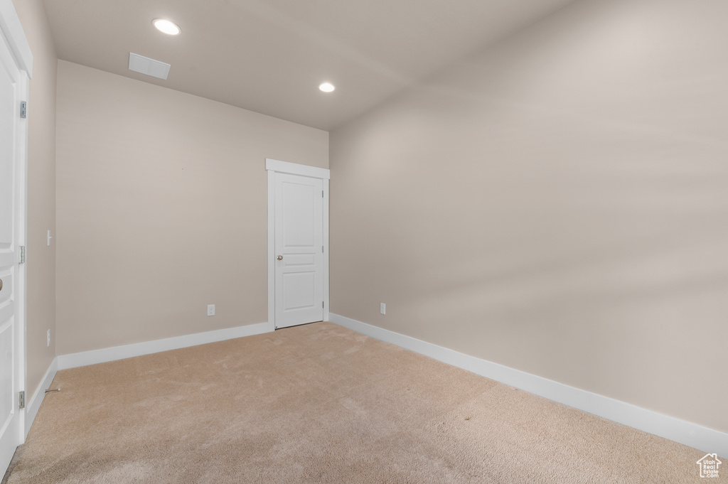Unfurnished bedroom featuring light carpet, recessed lighting, and baseboards