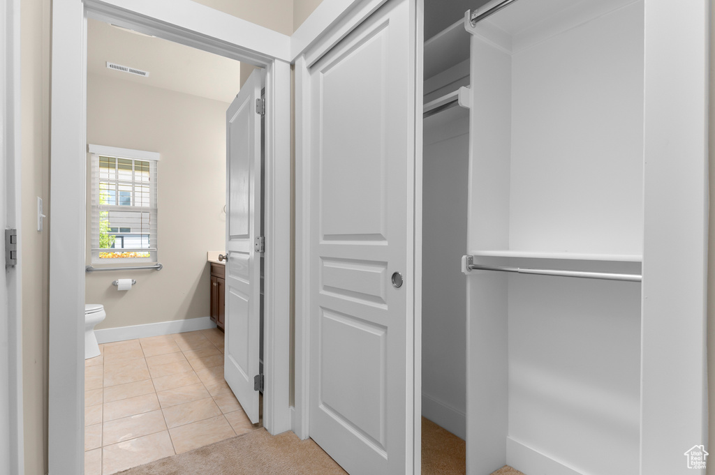 Bathroom with vanity, toilet, tile patterned flooring, and baseboards