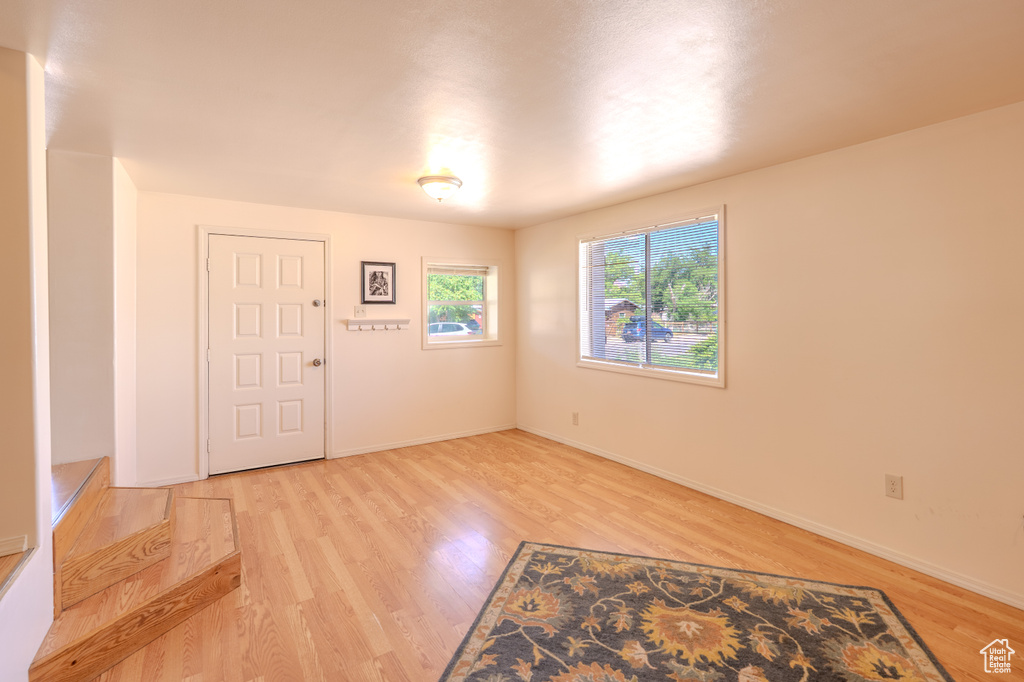 Entryway with light wood-style flooring and baseboards