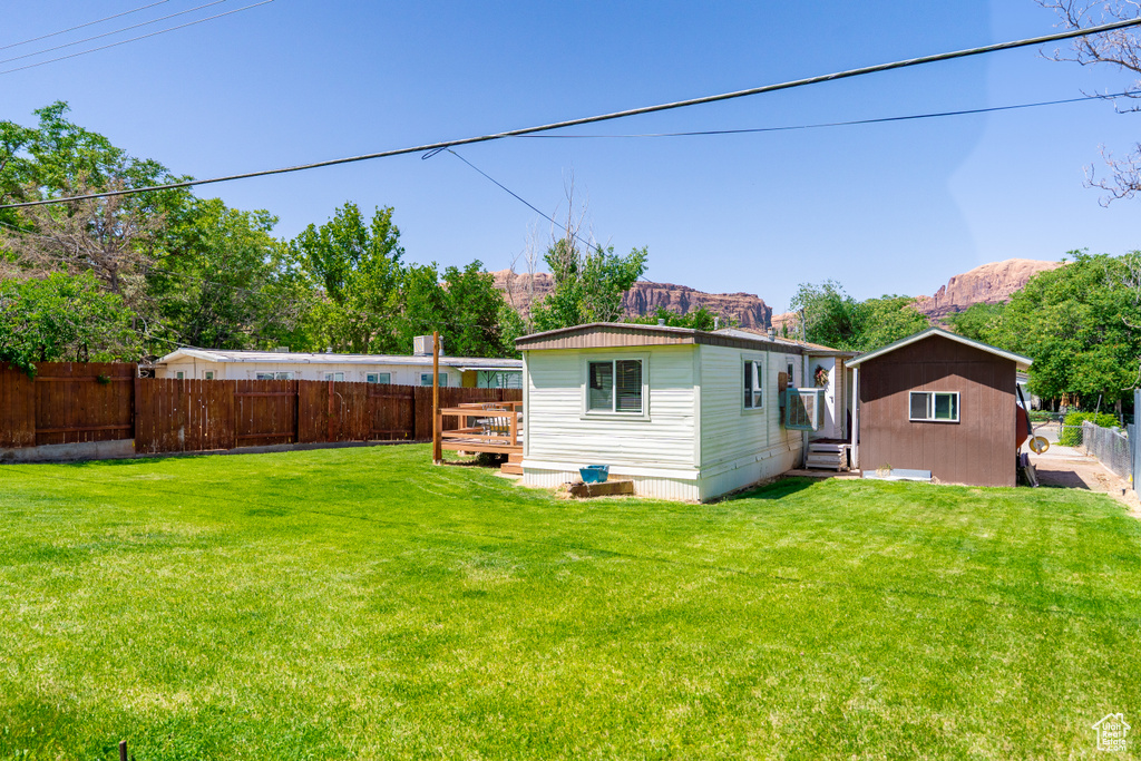 View of yard featuring a deck with mountain view