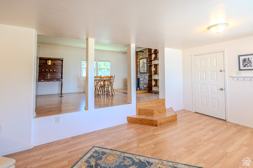 Entryway with wood finished floors and baseboards