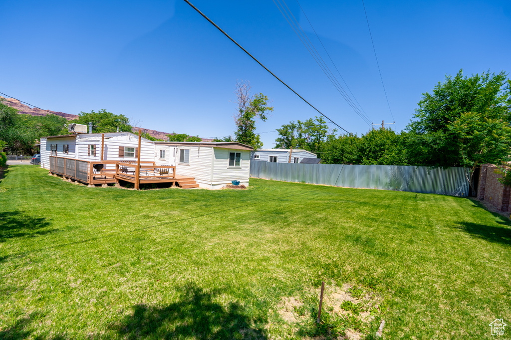 View of yard with a wooden deck