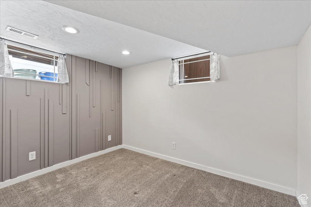 Basement featuring carpet floors, baseboards, and recessed lighting