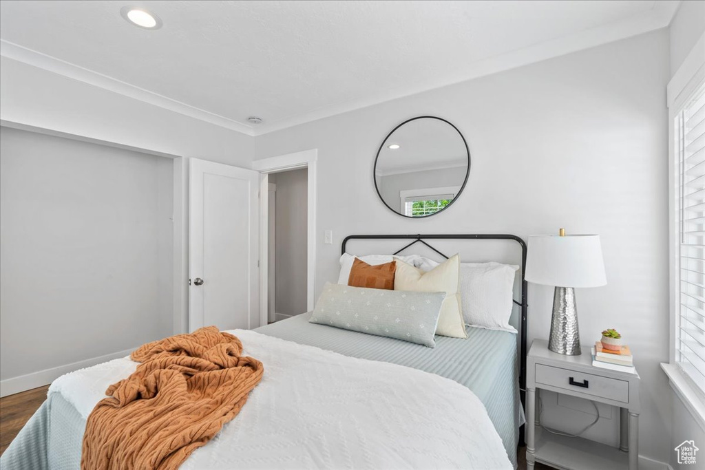 Bedroom with wood finished floors, baseboards, and recessed lighting