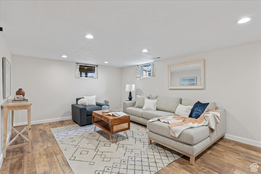 Living area featuring light wood finished floors, baseboards, and recessed lighting