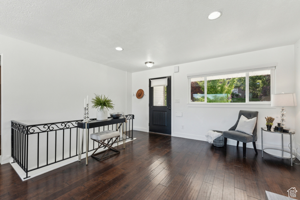 Foyer with wood-type flooring, baseboards, and recessed lighting