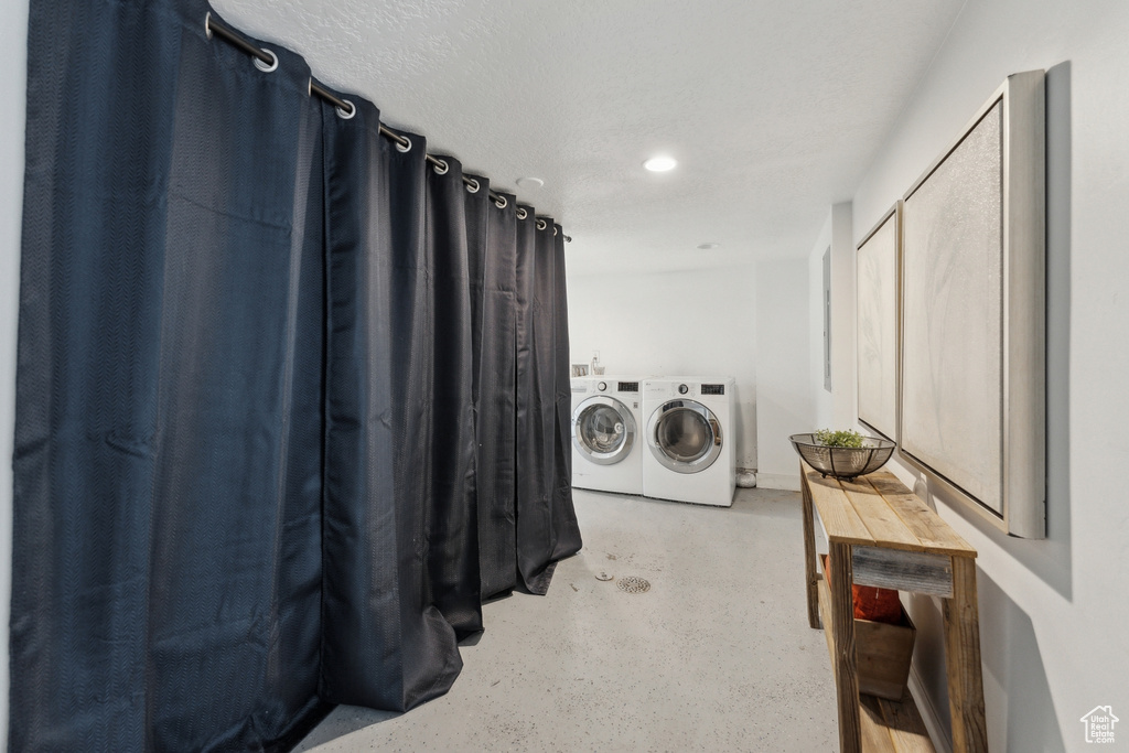 Washroom featuring washer and dryer and recessed lighting