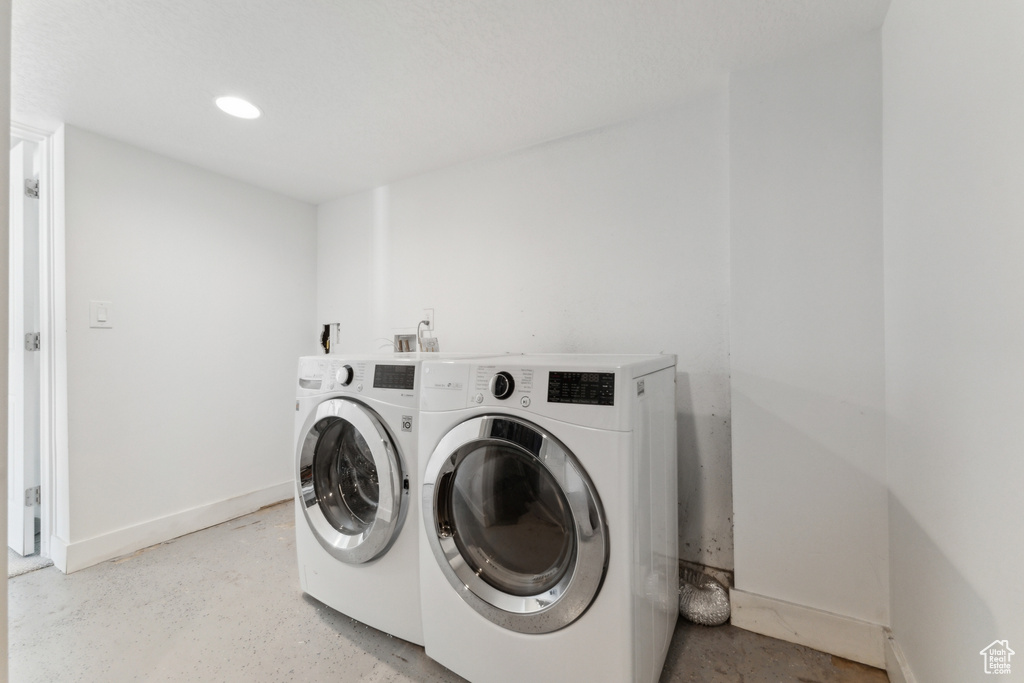 Washroom featuring washer and dryer, baseboards, and recessed lighting