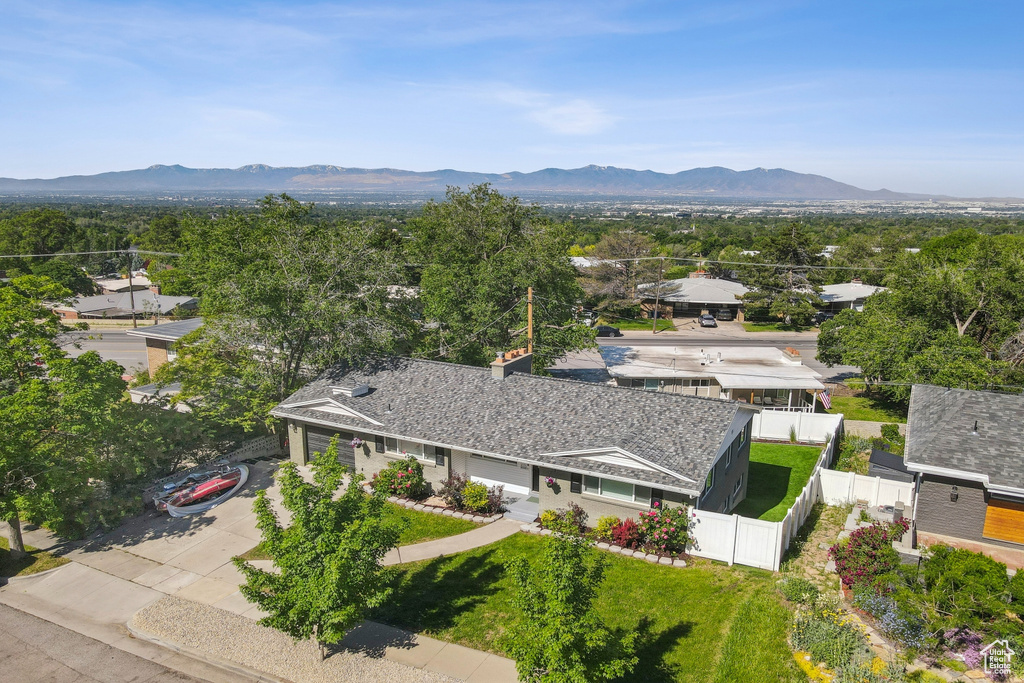 Aerial view of property and surrounding area with a mountain backdrop