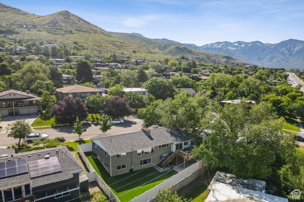 Aerial perspective of suburban area featuring a mountainous background