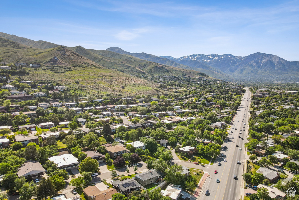 Aerial perspective of suburban area featuring a highway and a mountain backdrop