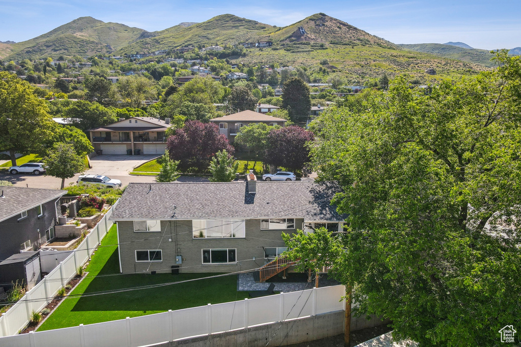 Aerial view of property and surrounding area featuring mountains