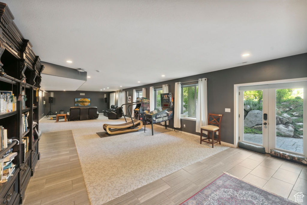Living area featuring french doors, wood tiled floors, baseboards, and recessed lighting