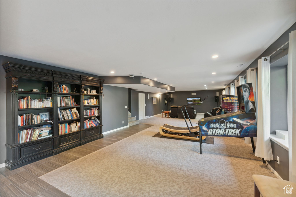 Rec room with baseboards, recessed lighting, wood finished floors, and carpet floors