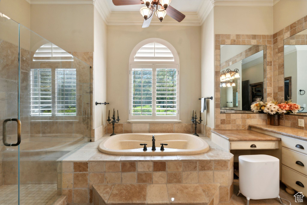Full bathroom featuring ornamental molding, a garden tub, ceiling fan, a shower stall, and vanity