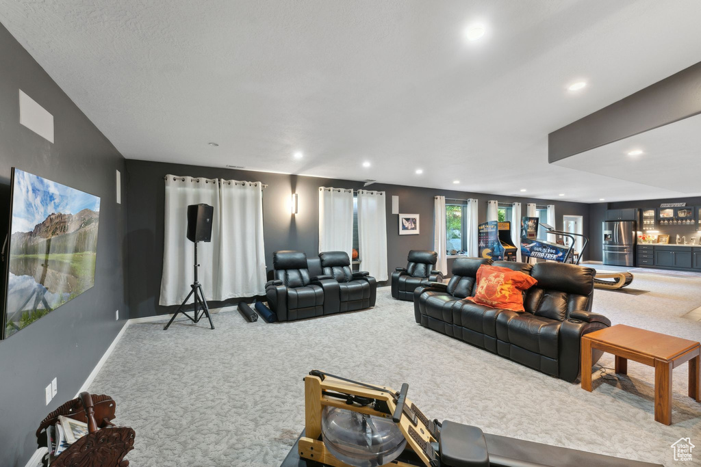 Living area with carpet, baseboards, and recessed lighting