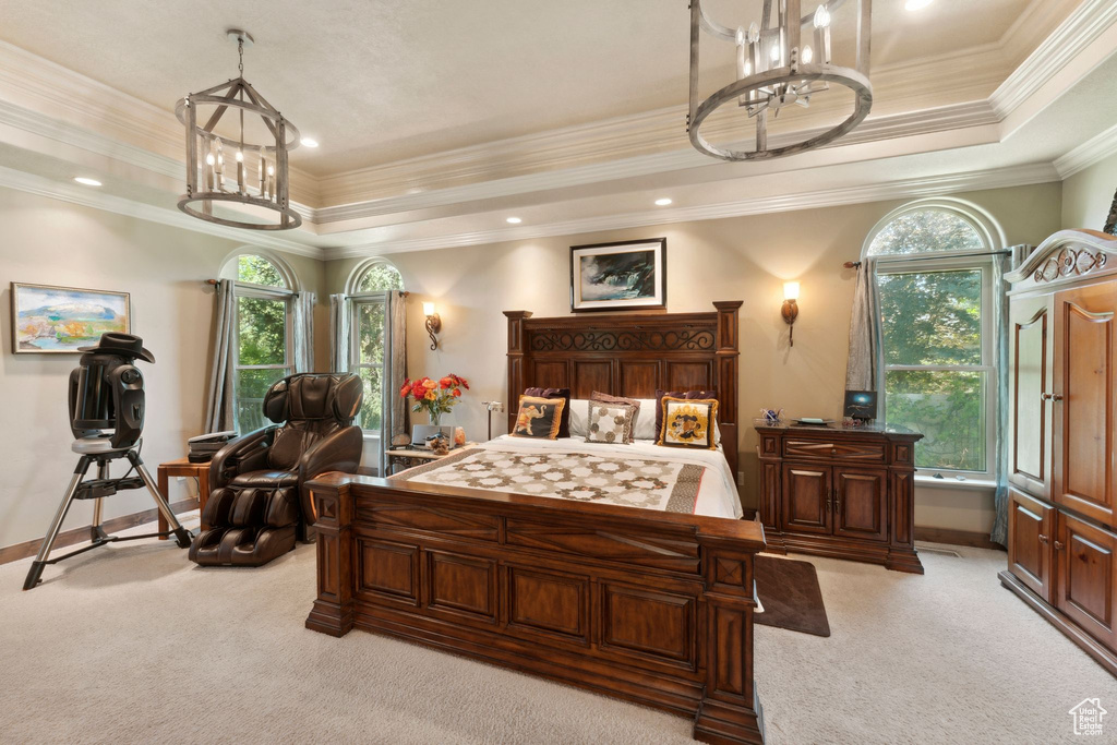 Bedroom featuring a chandelier, light carpet, baseboards, a raised ceiling, and crown molding
